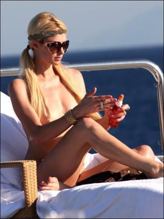 Topless Paris Hilton Applying Suntanning Lotion