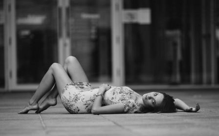 Girl Lies On Pavement Focus Doors Outside Short Skirt